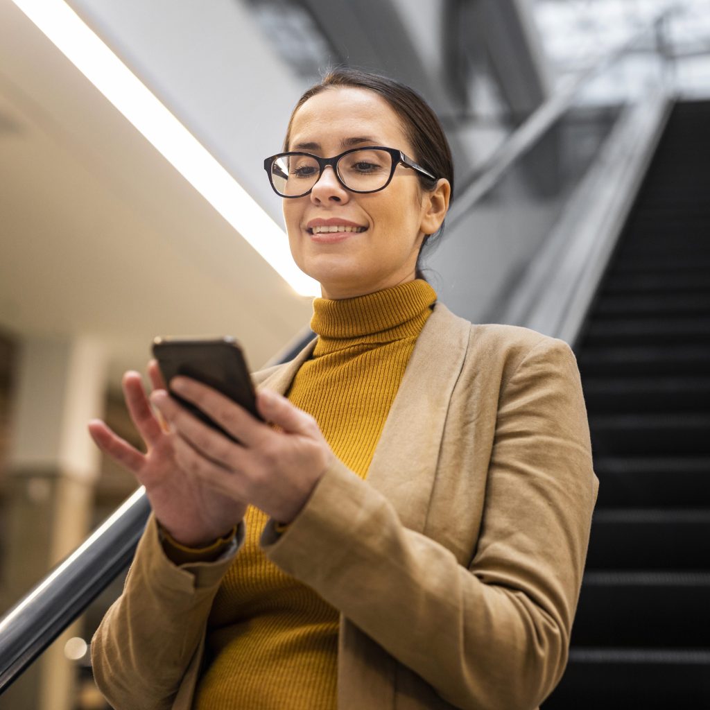 medium shot smiley woman with phone