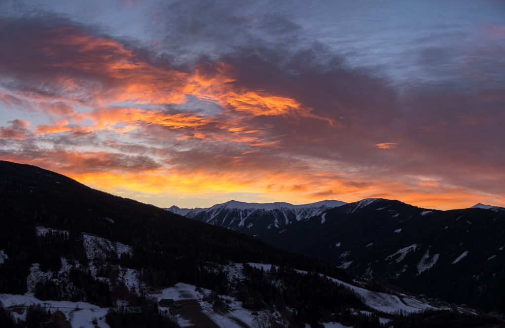 mesmerizing view of the mountains covered in snow during sunrise