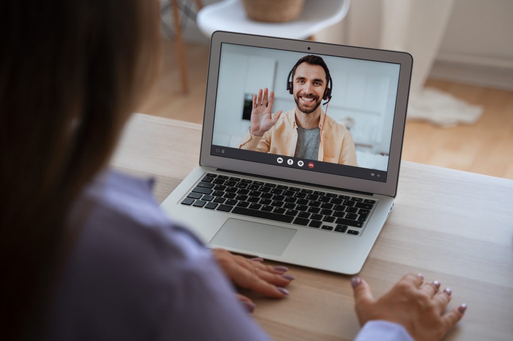 woman having video call home laptop device